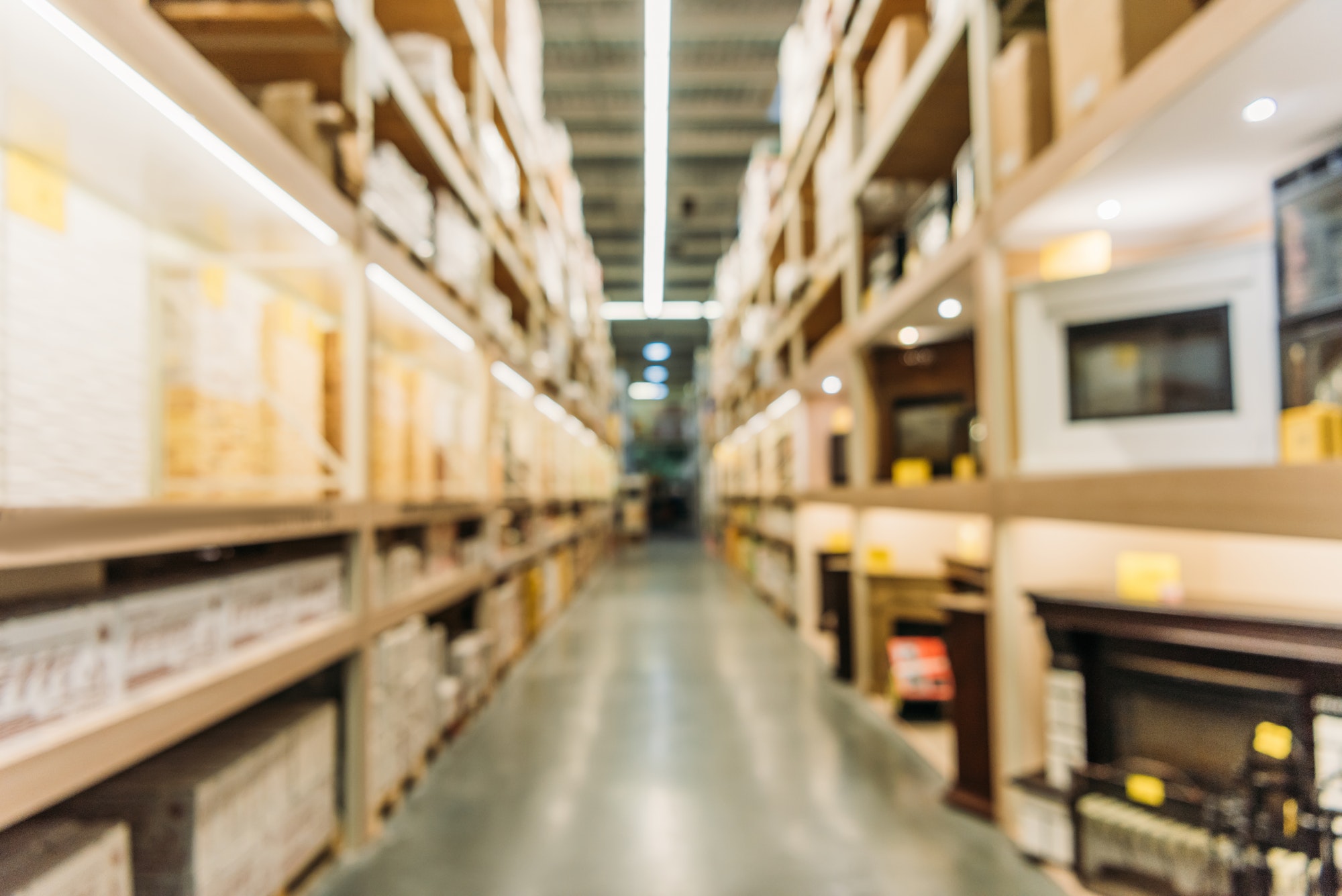 blurred view of shelves with boxes in warehouse