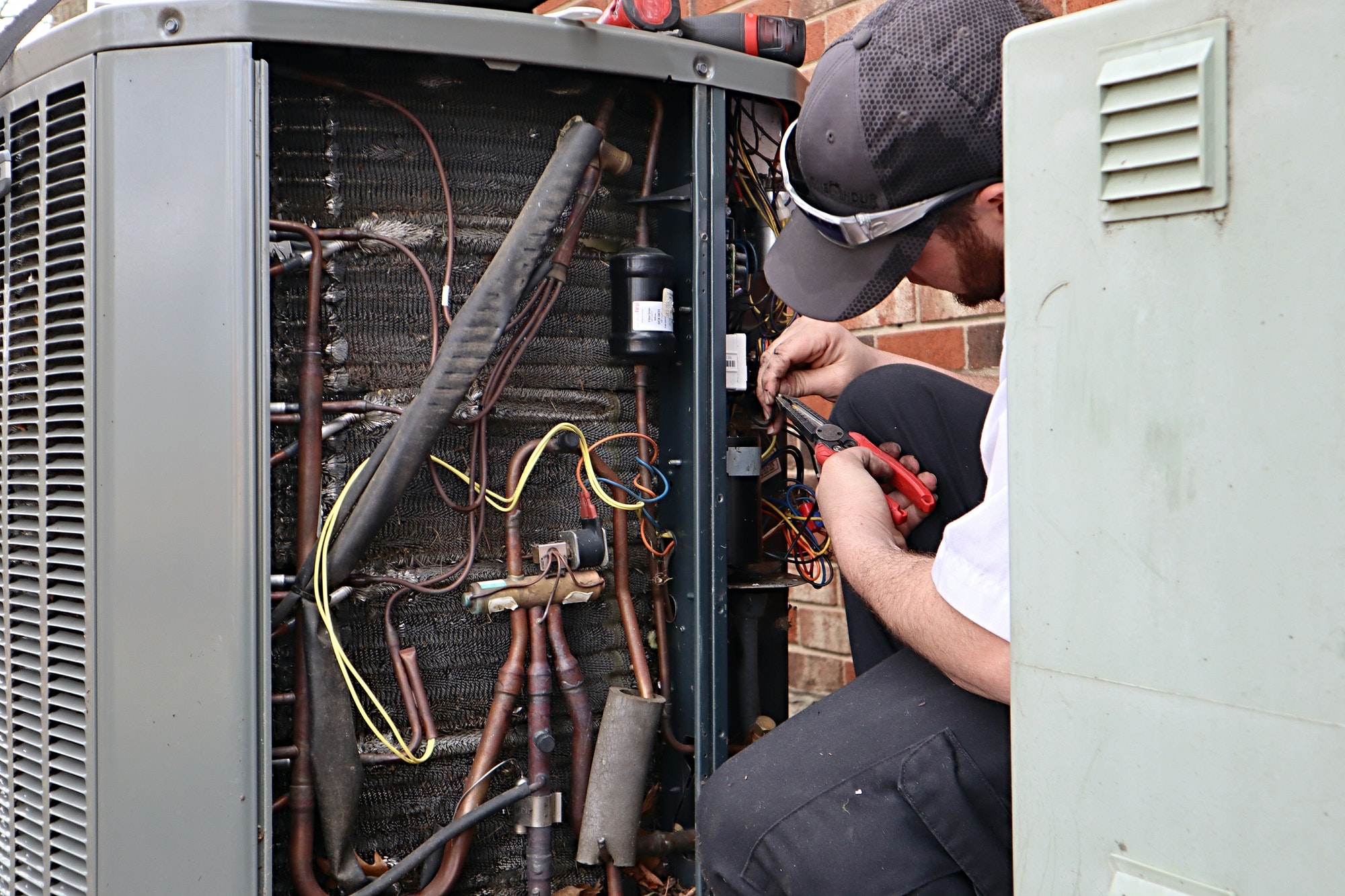 Service repair being done on a heat pump hvac system