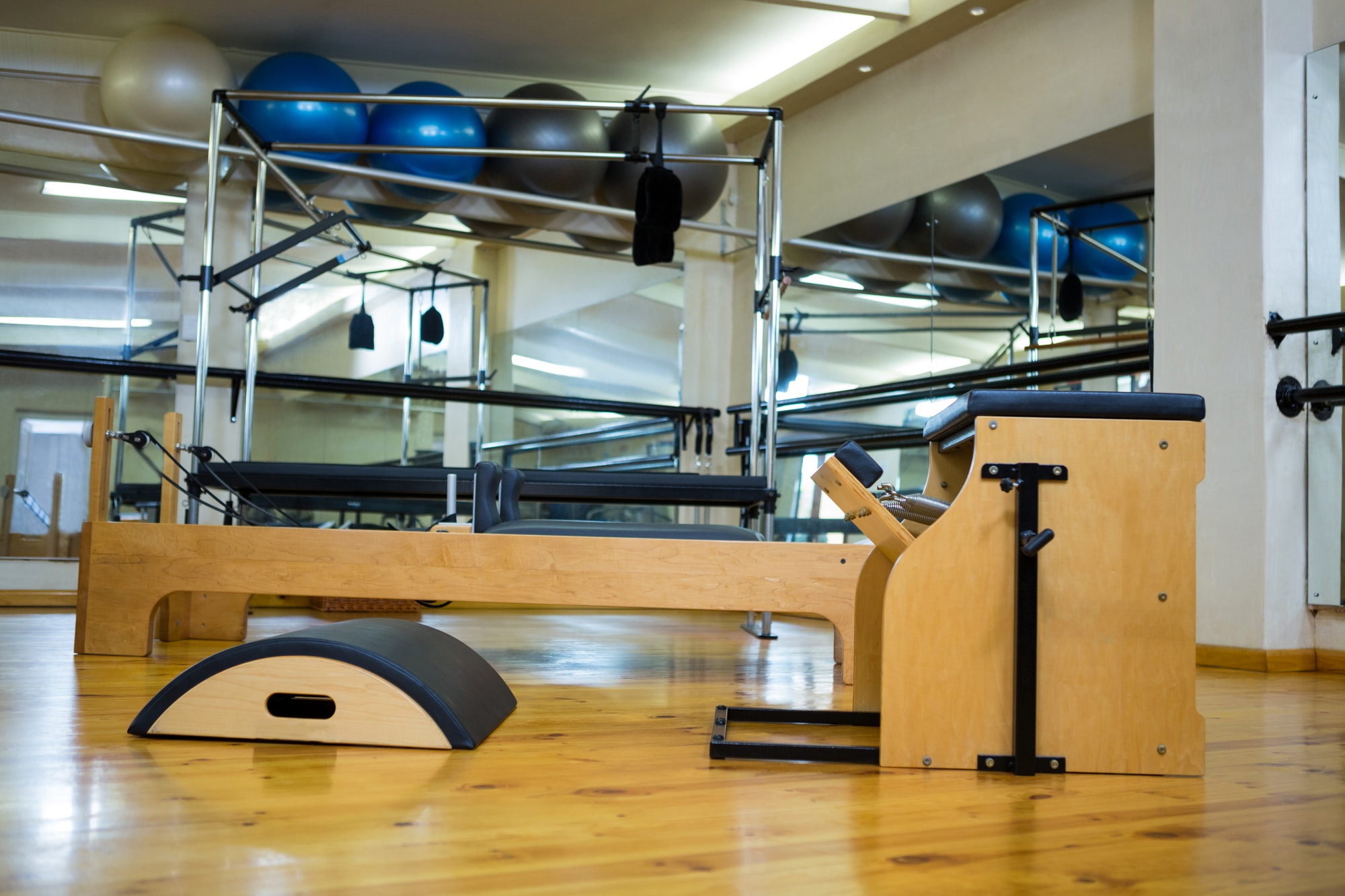 Various gym equipments on wooden floor